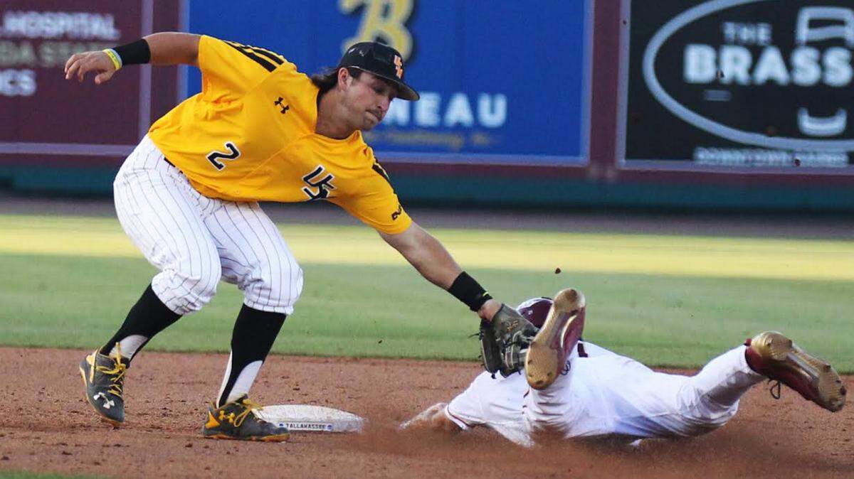 JOE HARPER/BIG GOLD PHOTOGRAPHY 
 Southern Miss shortstop Nick Dawson, left, makes the tag on Florida State's Ben Deluzio as he slides into second base during the fifth inning Saturday at Dick Howser Stadium in Tallahassee, Fla. Deluzio was called safe and FSU won the game 7-2.