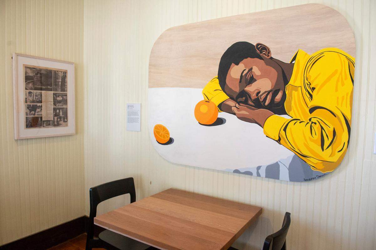 A painting of a Shearwater worker by Adrienne Dominick decorates a wall inside The Traveler, a new extension to the Walter Anderson Museum of Art, in Ocean Springs on Wednesday, April 16, 2025. The Traveler features an array of artworks as well as serving as a cafe.