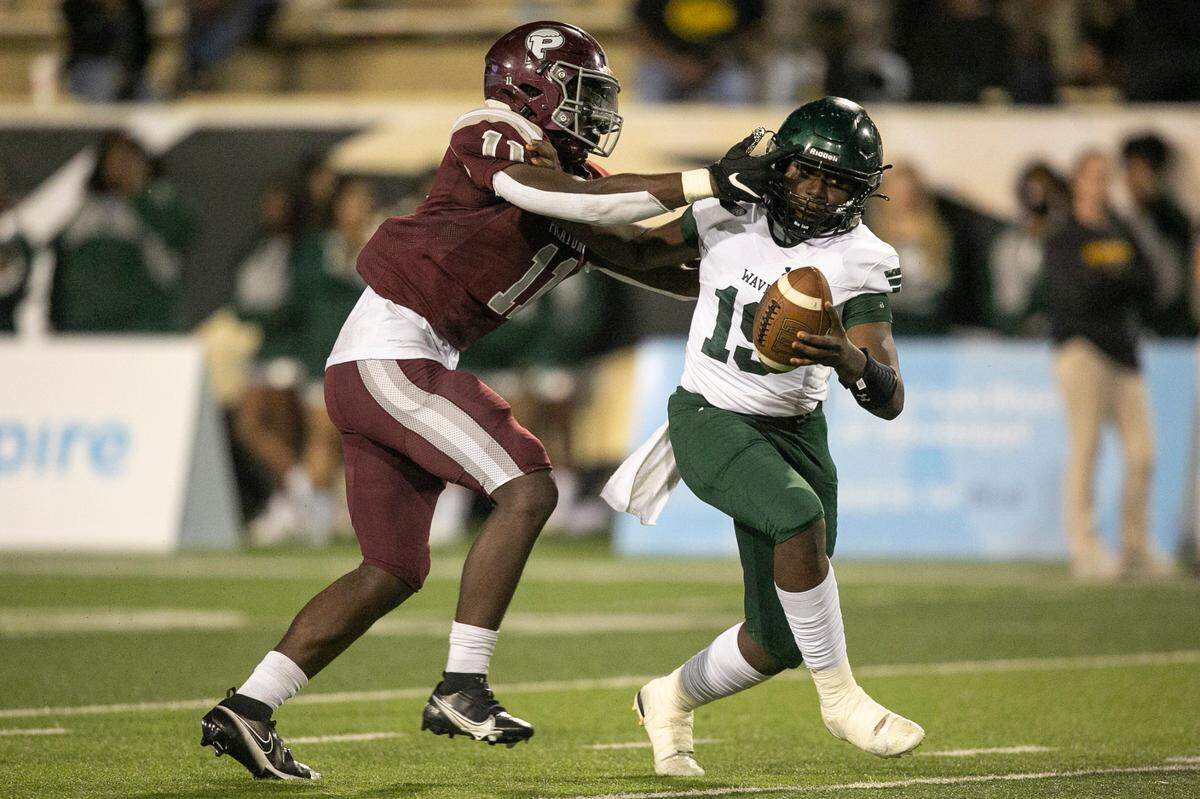 West Point’s Quinterion Tillman-Evans tries to push off Picayune’s Jamonta Waller during the 5A State Championship game at M.M. Roberts Stadium in Hattiesburg on Saturday, Dec. 4, 2021.