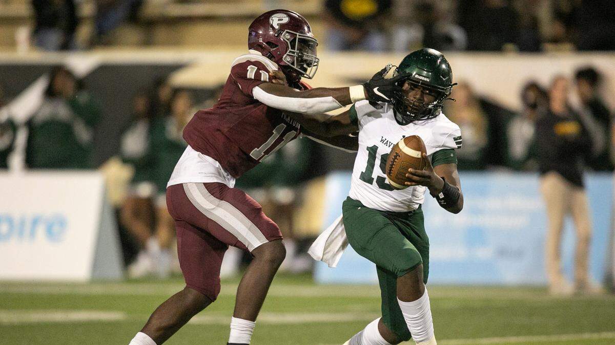 West Point’s Quinterion Tillman-Evans tries to push off Picayune’s Jamonta Waller during the 5A State Championship game at M.M. Roberts Stadium in Hattiesburg on Saturday, Dec. 4, 2021.