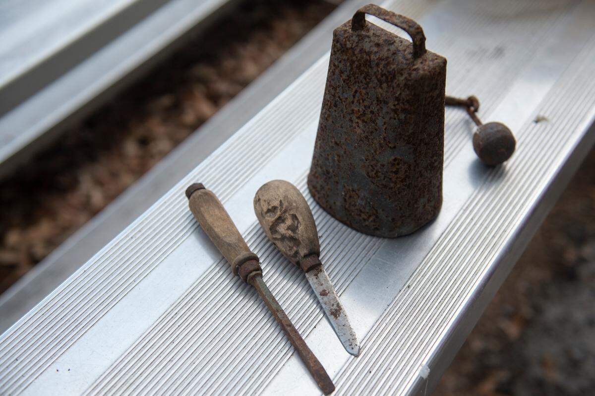 A cowbell, oyster shucking tool and a woodworking tool that belonged to Cushman’s grandfather, John Lee, on Monday, June 24, 2024.