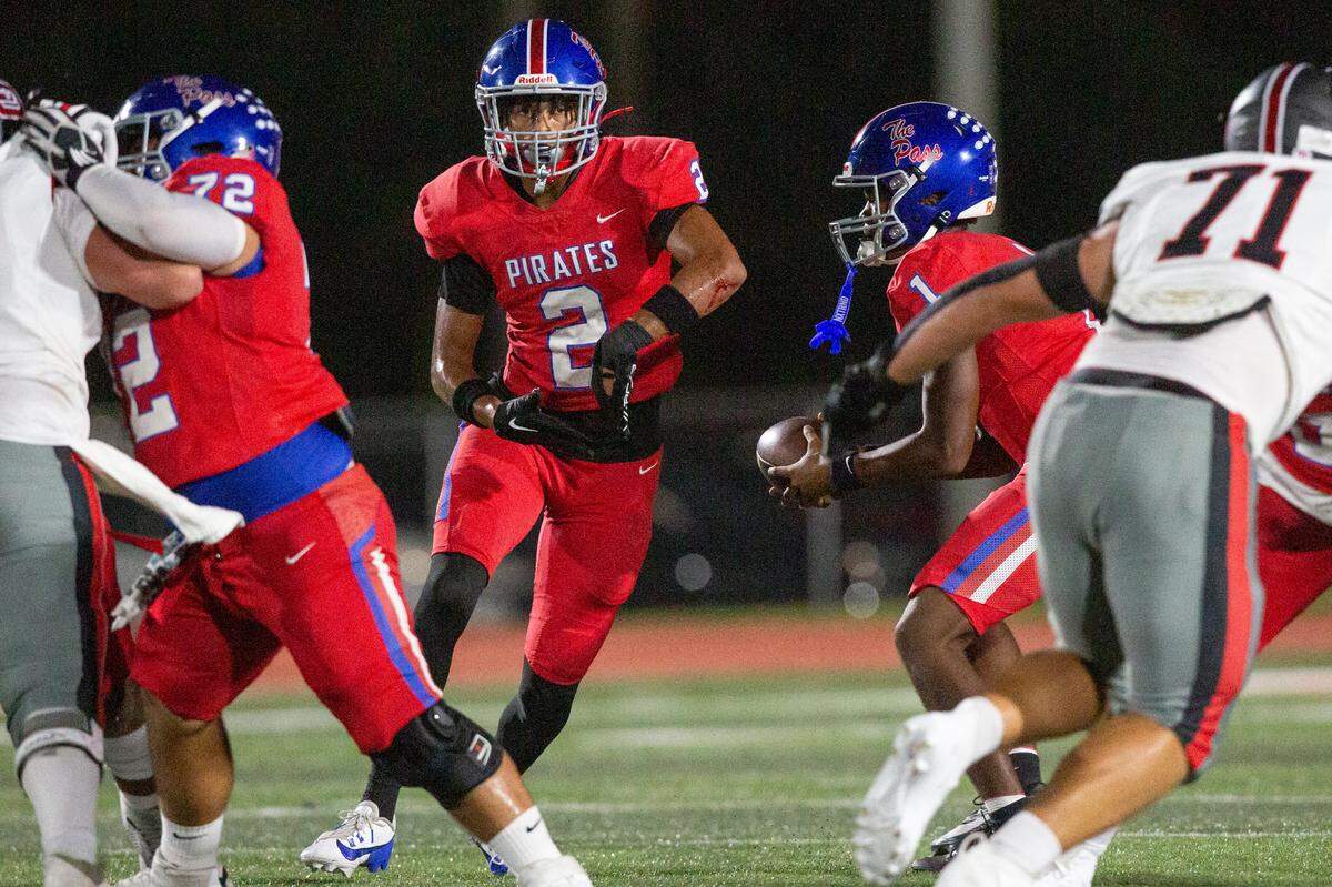 Pass Christian’s Paris Trivillion fakes a handoff to Jacques Alexander during a game between Pass Christian and St. Stanislaus at Francis McDonald Stadium in Pass Christian on Friday, Sept. 20, 2024.
