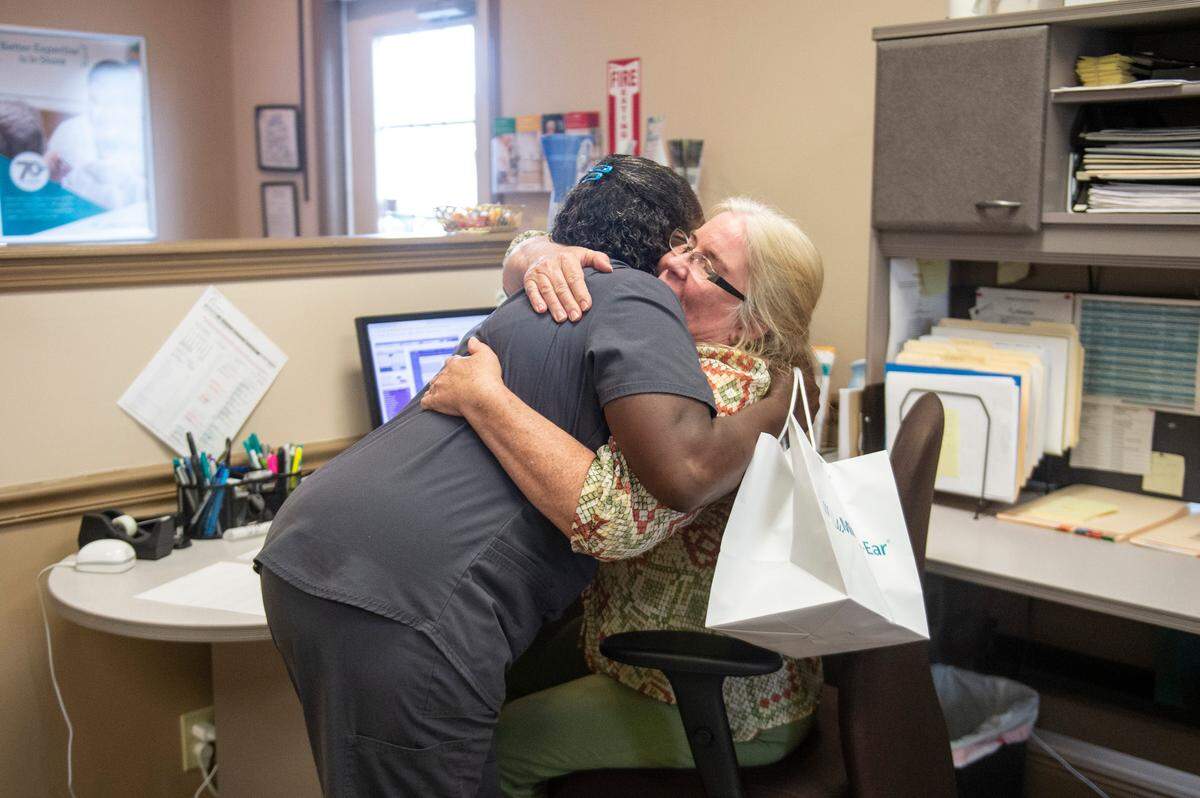 Libby Riley embraces the receptionist at Miracle Ear in Gulfport after receiving hearing aids on Wednesday, April 20, 2022. Riley, who has had hearing loss since she was a baby, was able to hear out of her left ear for the first time with the help of the hearing aids.