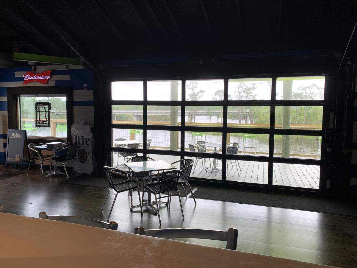A garage door with windows to capture the views at Pier 15 and rolls open to let in the breeze from the river.
