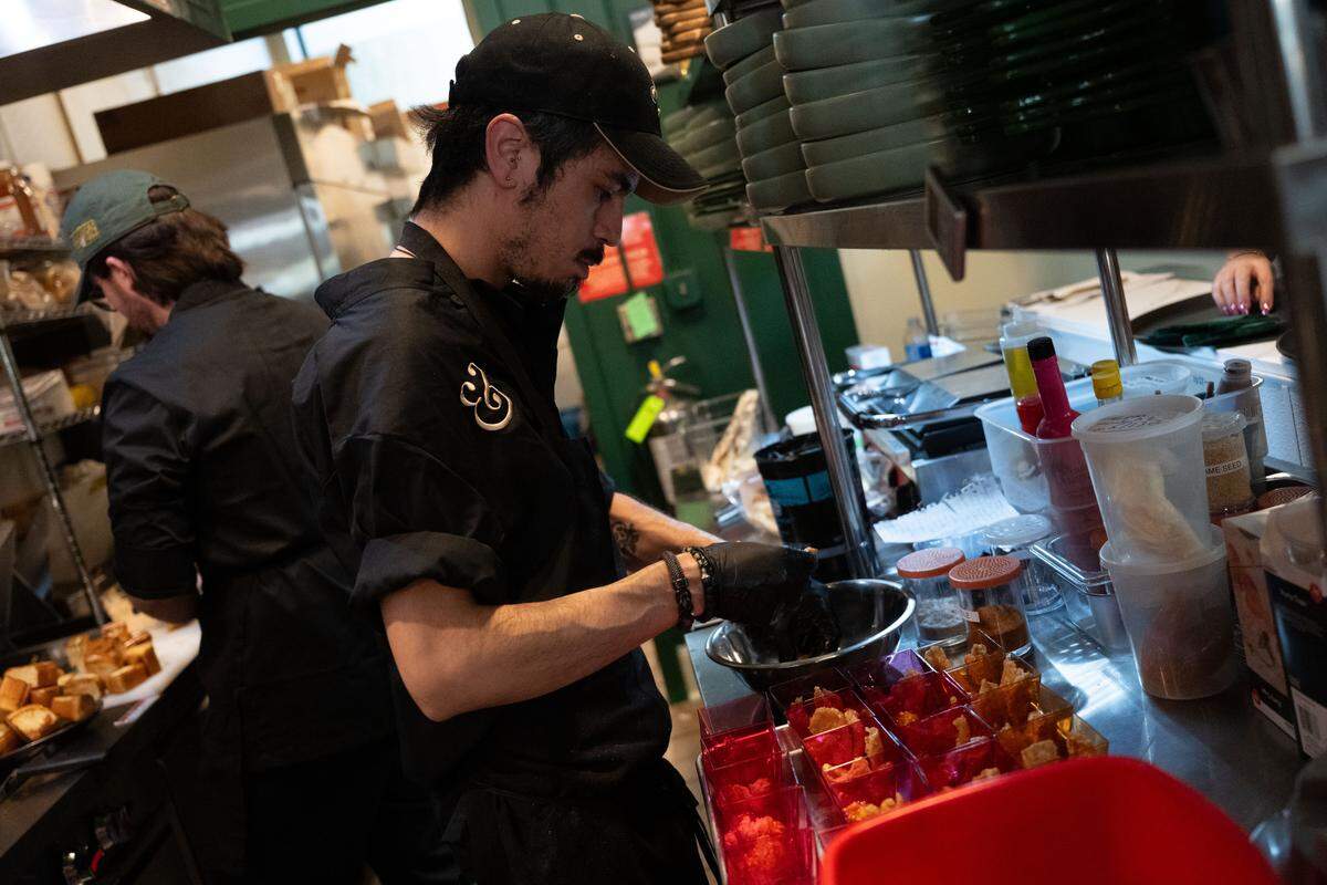 A chef prepares fried pork rinds Thursday.