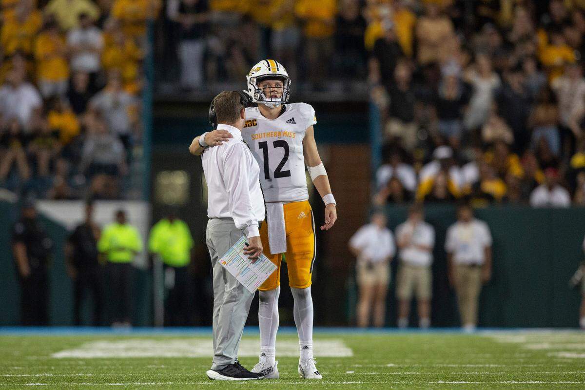 Southern Miss Coach Will Hall talks to Southern Miss Golden Eagles quarterback Zach Wilcke (12) before one of the last plays during a game against Tulane at Yulman Stadium in New Orleans on Saturday, Sept. 24, 2022.