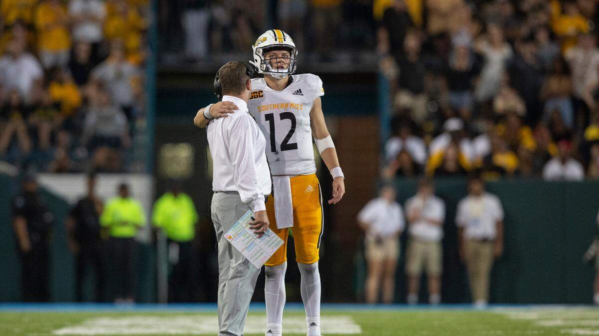 Southern Miss Coach Will Hall talks to Southern Miss Golden Eagles quarterback Zach Wilcke (12) before one of the last plays during a game against Tulane at Yulman Stadium in New Orleans on Saturday, Sept. 24, 2022.