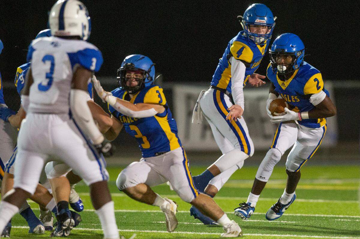 Resurrection quarterback Luke Schnoor hands the ball off to Daniel Pickens during a game against French Camp Academy at Gautier High School in Gautier on Friday, Nov. 3, 2023.