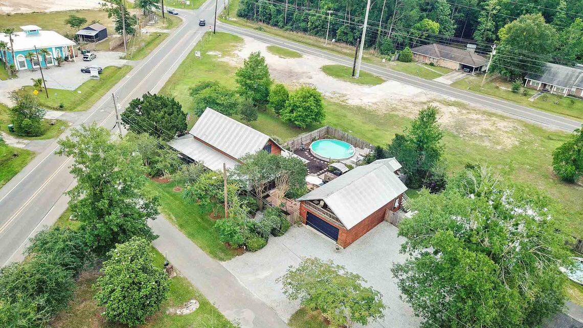 Property known as Breezy Porches sits off Nicholson Avenue in Waveland. Owners Glenn Hood and Charles “Chuck” Underwood rebuilt the main house with log cabin siding after Hurricane Katrina, eventually adding upstairs and downstairs apartments as short-term rentals in the building on the right. The property is on the market for $449,000.