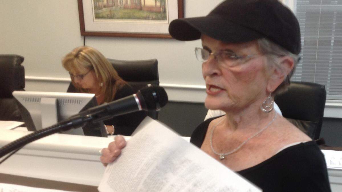 KAREN NELSON/SUN HERALD 
 Jane Beaugez shows Ocean Springs aldermen a petition signed by neighbors against the short-term rental at 215 Halstead Road.