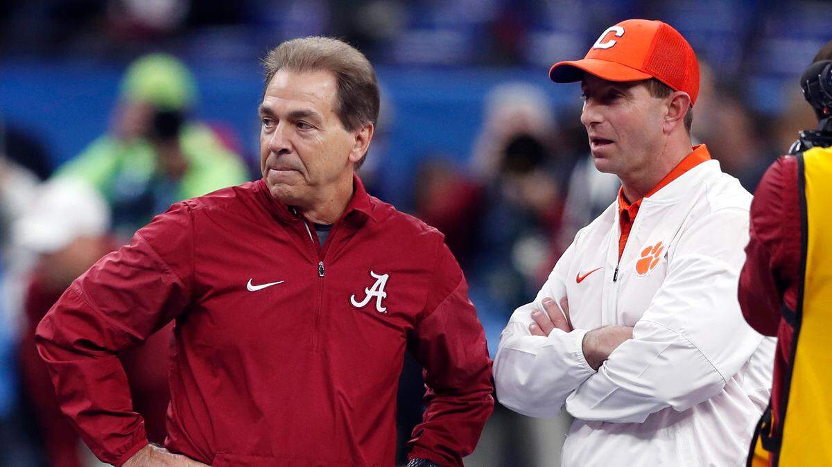 In this Jan. 1, 2018, file photo, Alabama head coach Nick Saban, left, and Clemson head coach Dabo Swinney talk before the Sugar Bowl semifinal playoff game for the NCAA college football national championship in New Orleans.