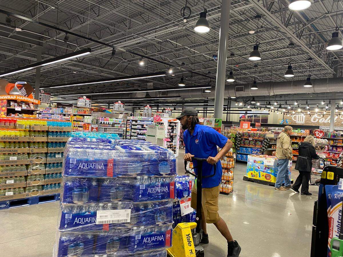 Water is plentiful at Rouse’s Market on Pass Road in Gulfport Wednesday morning. Employee Ricky Blackmore stacks more cases as people stock up ahead of Hurricane Francine landfall, expected in Louisiana late afternoon or early evening Wednesday.