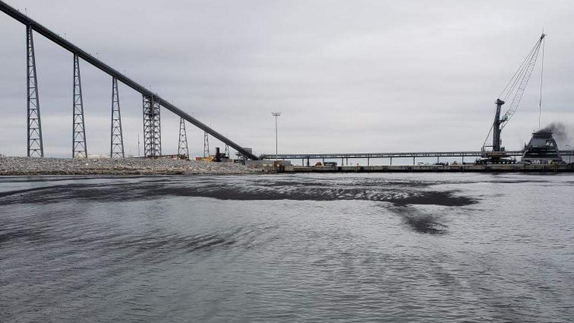 A mysterious black dust coats boats and the water at the Gulfport Harbor. What is it?