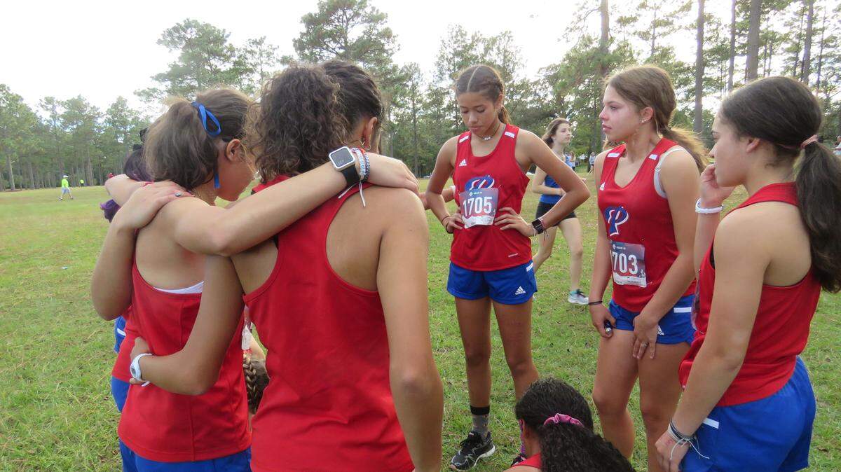 The Pascagoula High School girls’ cross country team stands at the starting line at the regional meet on Oct. 26, 2021.