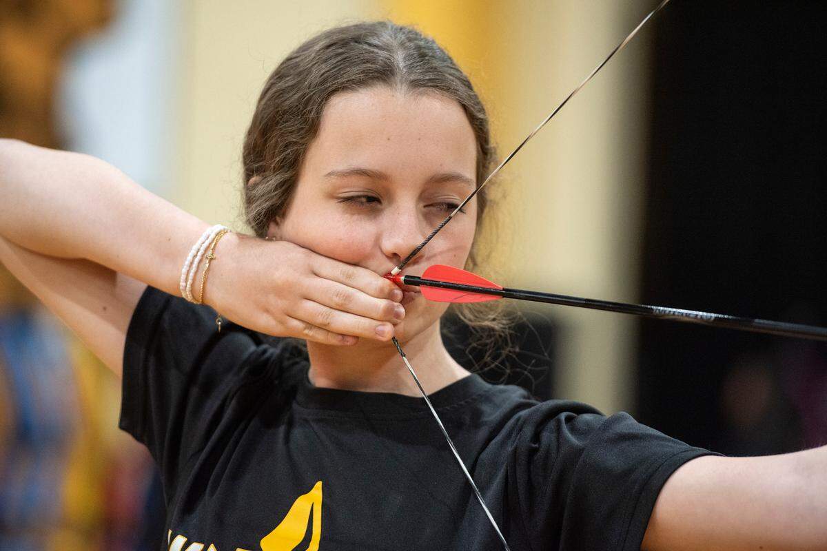 Eleventh grader Avary Peterson, a member of the D’Iberville High School archery team, lines up her shot during a practice at D’Iberville High School on Thursday, April 18, 2024.