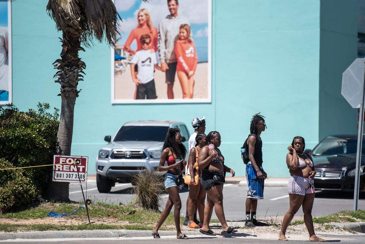 Spring breakers walk along Highway 90 during Black Spring Break in Biloxi on Saturday, April 13, 2024