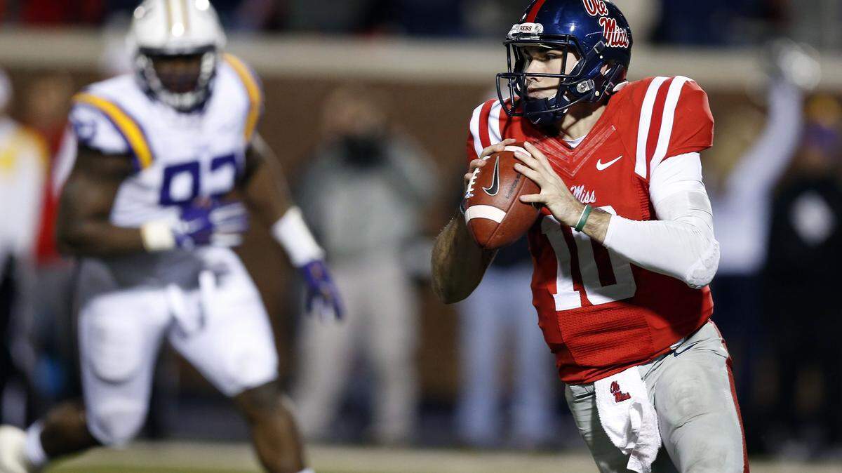 ROGELIO SOLIS/ASSOCIATED PRESS 
 Ole Miss quarterback Chad Kelly (10) looks for an open receiver as an LSU defender pursues in the second half of an NCAA college football game in Oxford, Saturday.