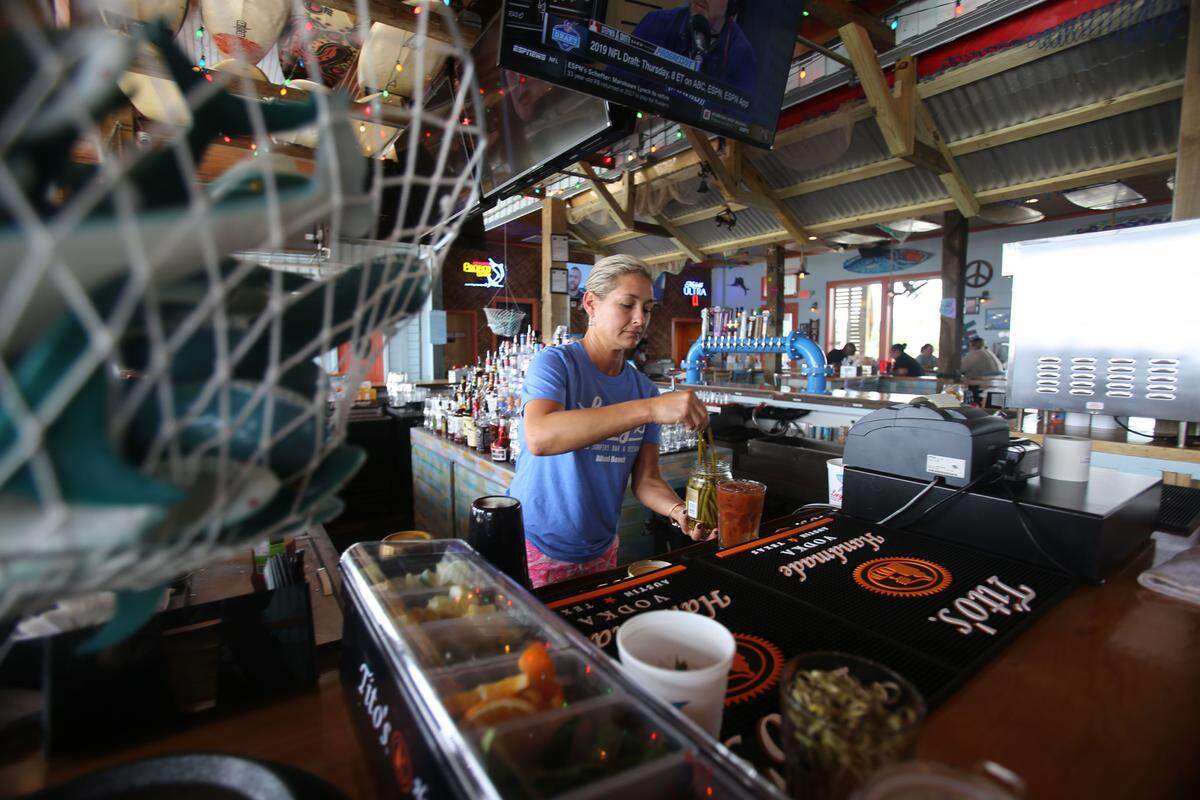 A bartender makes a bloody Mary at Lucy’s Retired Surfers Bar & Restaurant, which opened on the beach on Restaurant Row in Biloxi in 2019. Five years later, the restaurant is for sale or lease.