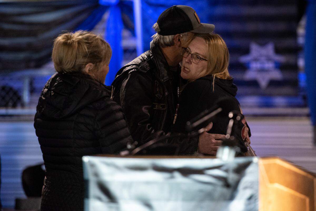 Family members of Sgt. Steven Robin embrace during a candlelit vigil for Bay St. Louis Sgt. Steven Robin and officer Branden Estorffe at Tiger Stadium in Bay St. Louis on Thursday, Dec. 15, 2022. Robin and Estorffe were killed on Wednesday when a woman shot both of them.
