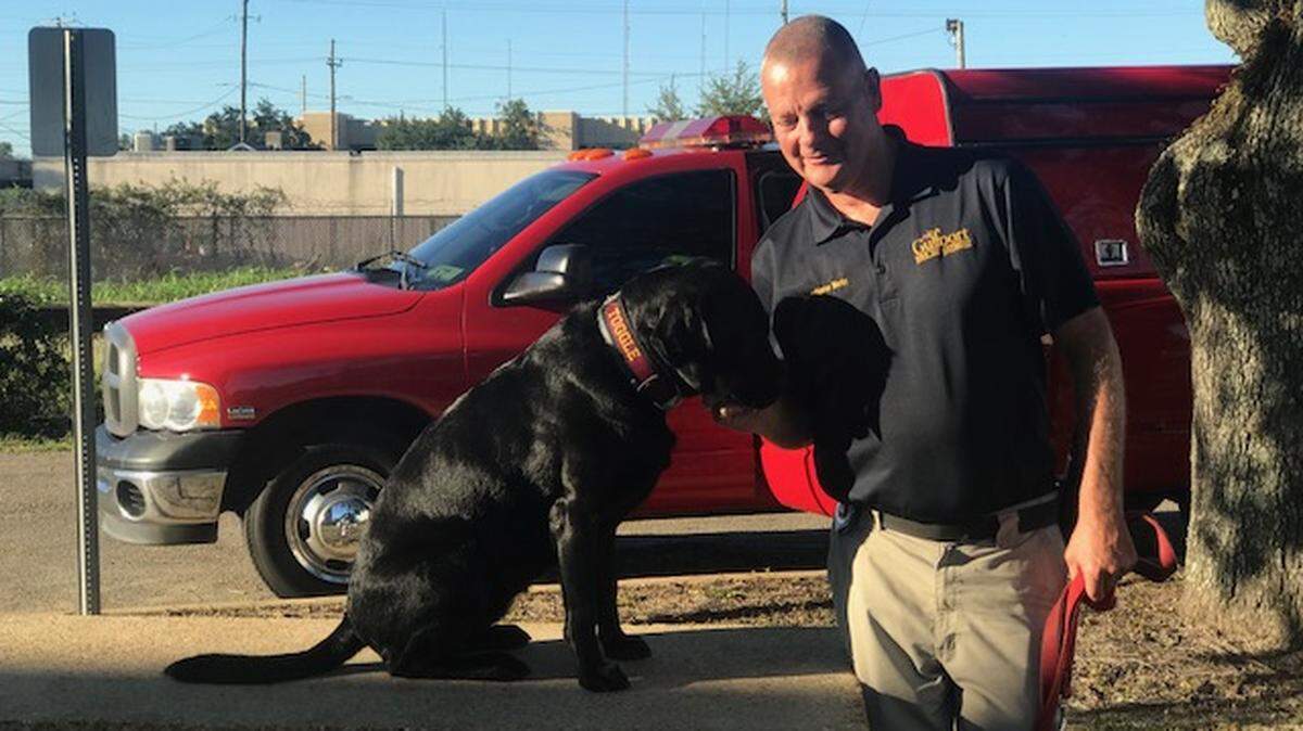 Fire Investigator Greg Marks is shown with his K9 Toggle, who detected the accelerants in a fired believed to be intentionally set on 20th Street on Wednesday, Oct. 10, 2018.