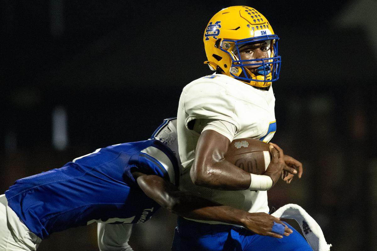 St. Martin quarterback Seth Crockett (6) runs with the ball during a football game at A.L. May Memorial Stadium on Friday, Sept. 12, 2025.  St. Martin won the game 21-3.