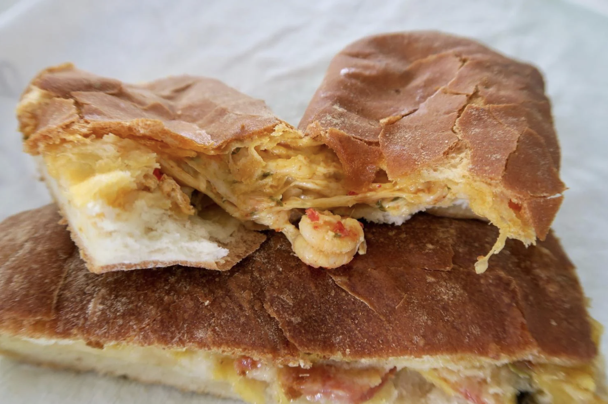 Crawfish bread is a classic dish at New Orleans Jazz Fest that draws many fans to the Panaroma Foods booth.