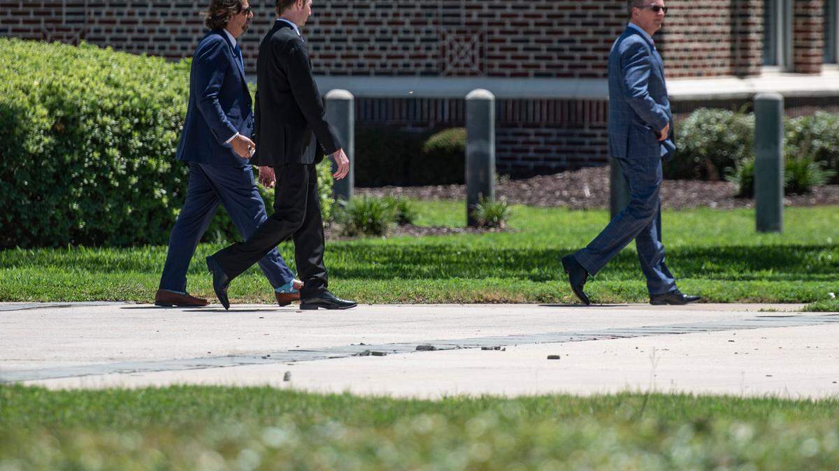 Brandon Reich, center, walks out of Dan M. Russell Federal Courthouse in Gulfport with his lawyers following a court appearance on Wednesday, July 27, 2022. Reich plead guilty in a health care fraud case involving hoarding personal protective equipment during the pandemic.