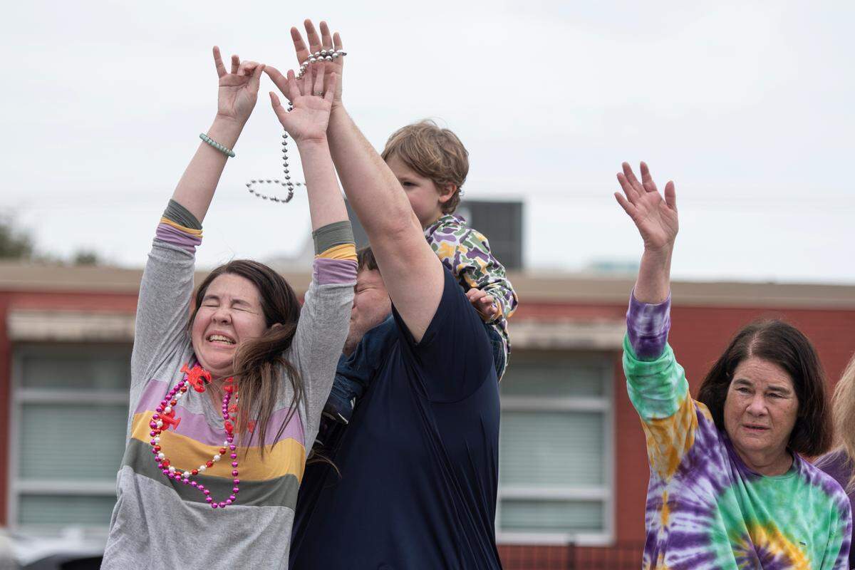 Paradegoers catch beads during the Krewe of Gemini parade in downtown Gulfport on Saturday, Feb. 10, 2024.