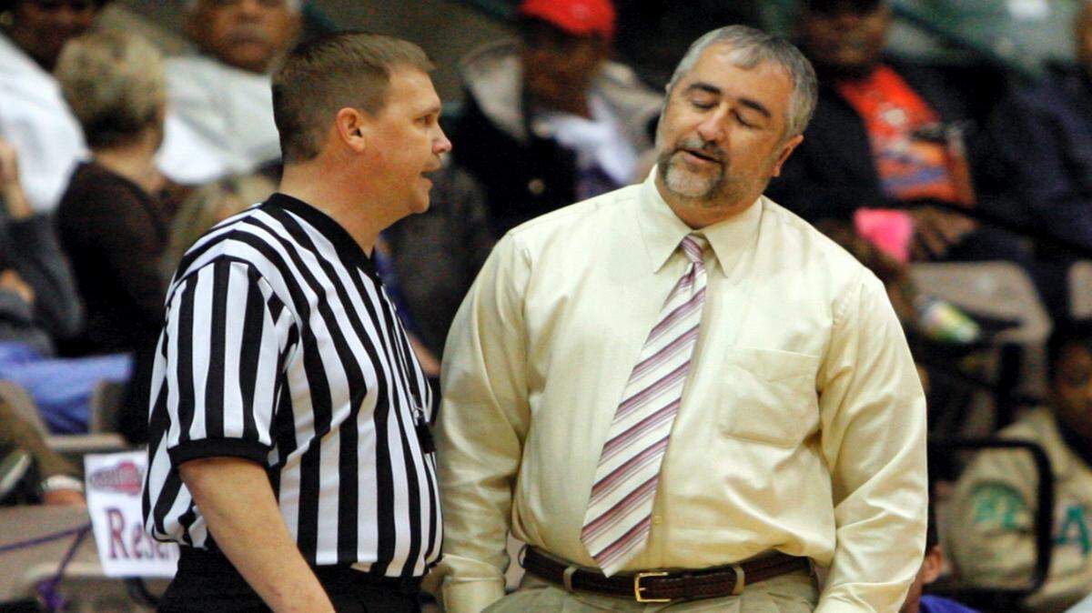 TIM ISBELL/THE SUN HERALD 
 Pass Christian coach Buddy Kennedy, right, makes his case with an official in Jackson.