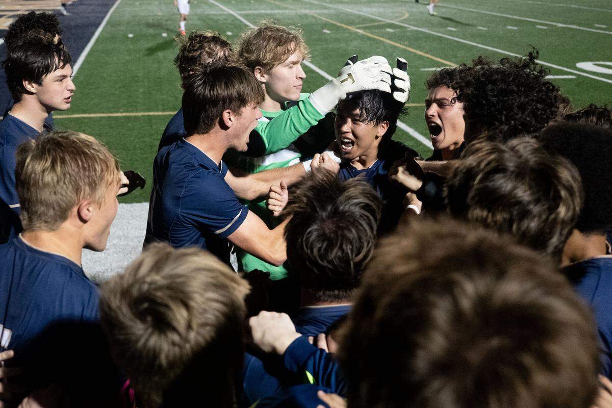 St. Patrick players celebrate with Lucas Kurihara (10) after scoring a goal during a soccer game at St. Patrick Catholic High School on Tuesday, Feb. 17, 2026