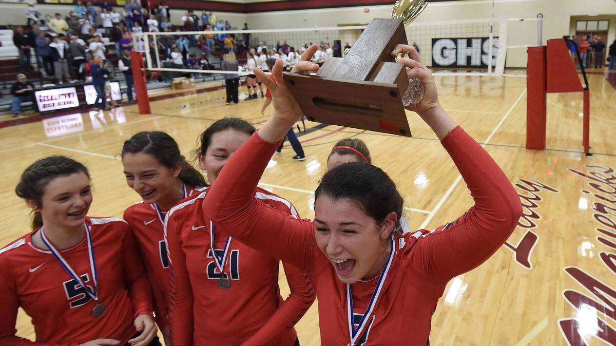 Madison Ladner (7) and the Hancock High School Lady Hawks celebrate with the runner-up trophy after losing to DeSoto Central in three games on Saturday, October 31, 2015, in the MHSAA State Volleyball Championships at Germantown High School in Gluckstadt, Miss.
