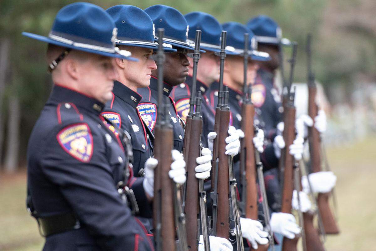 Mississippi Highway Patrol officers prepare to fire ceremonial blanks during the funeral of Bay St. Louis police officers Sgt. Steven Robin and Branden Estorffe at Gardens of Memory cemetery in Bay St. Louis on Wednesday, Dec. 21, 2022. Robin and Estorffe were killed responding to a call at a Motel 6 on Dec. 14.