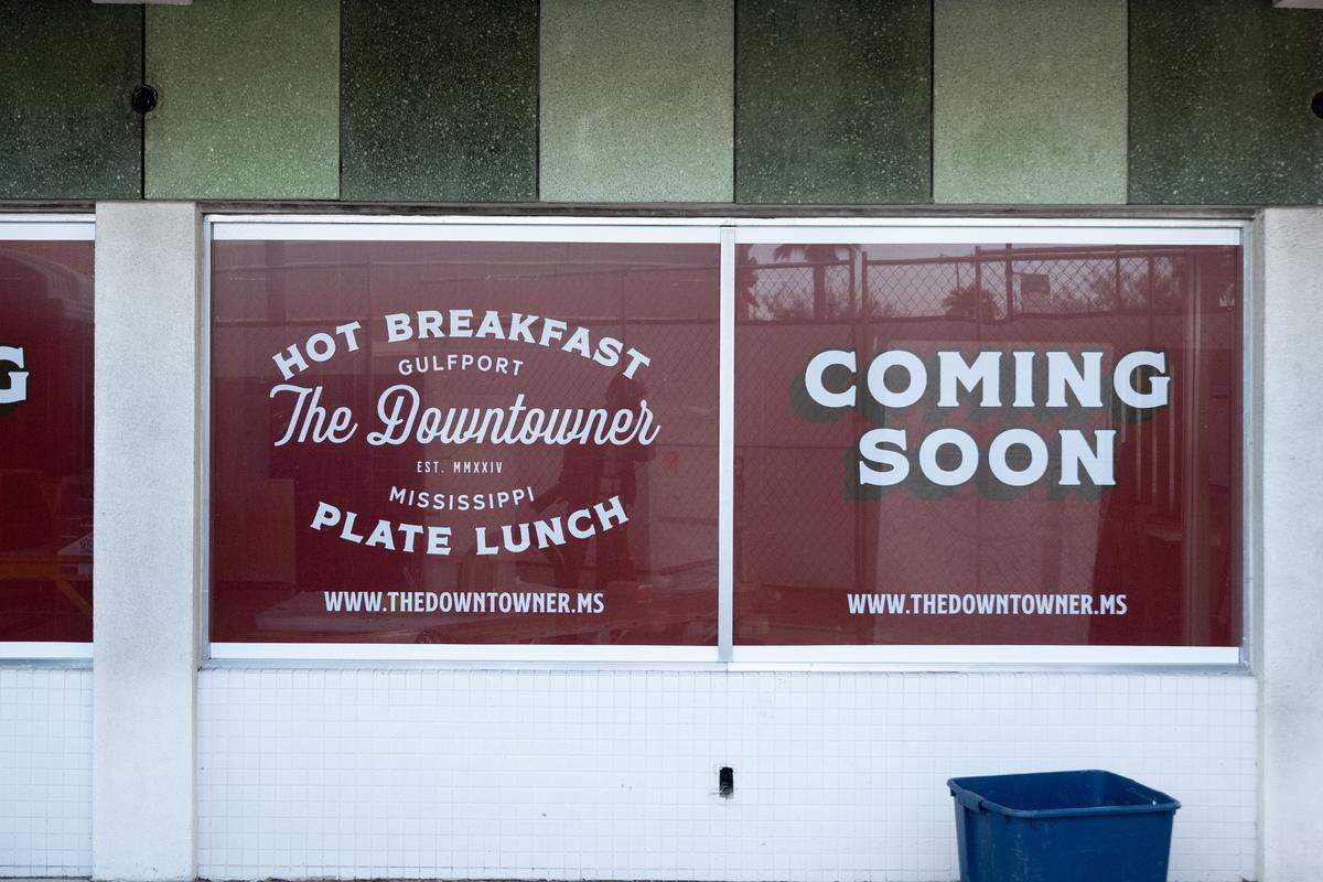 A coming soon sign hangs outside the former Triplett-Day building that is being transformed into The Downtowner restaurant in downtown Gulfport.