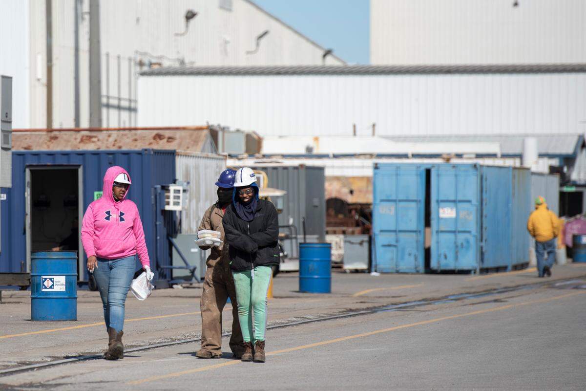 Workers walk through the shipyard at Ingalls Shipbuilding in Pascagoula in this 2022 file photo. The company is looking to hire thousands of shipbuilders to work on ships for the Navy and Coast Guard.