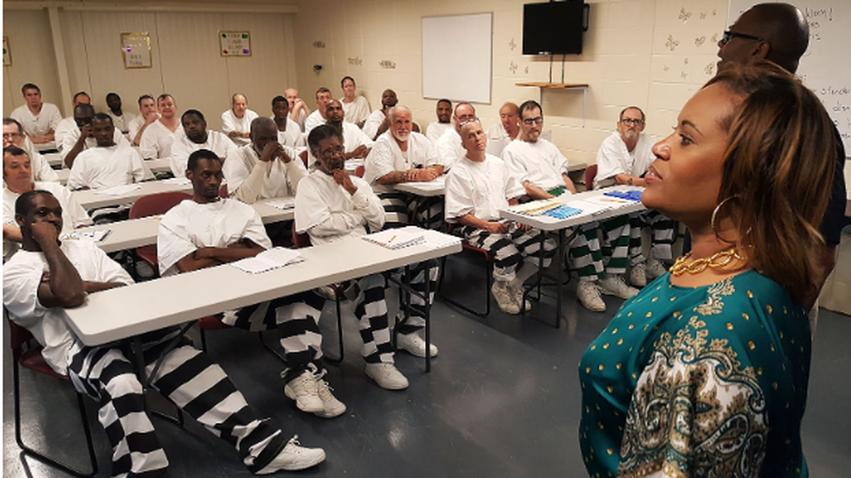 Mississippi Department of Corrections Deputy Commissioner of Institutions Jerry Williams, upper right, helps teach inmates at South Mississippi Correctional Institution in Leakesville about job interviewing strategies while Corrections Commissioner Pelicia Hall observes. The class is part of Hall’s big vision to turn Mississippi’s prisons into places that teach and train offenders.