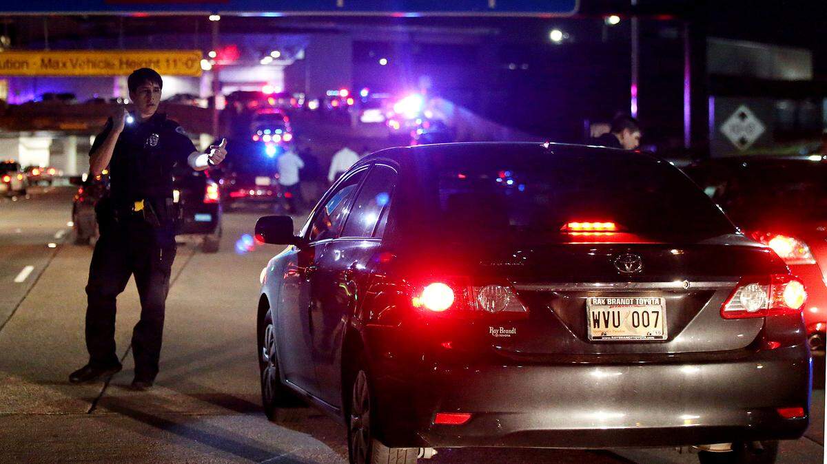 An officer directs traffic at the entrance to New Orleans International Airport, Friday, March 20, 2015, in Kenner, La.