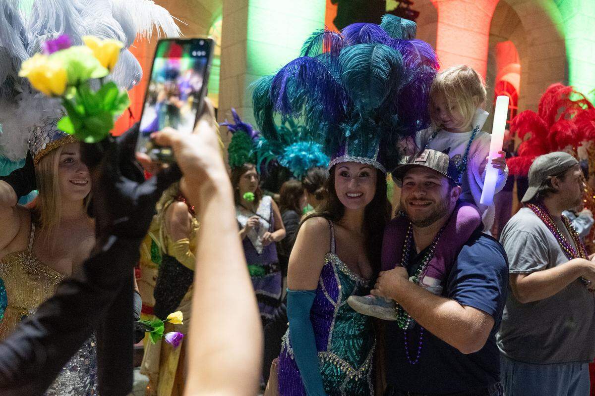 Parade attendees pose for a photo during a 12th Night Celebration in Biloxi on Monday, Jan. 5, 2026.