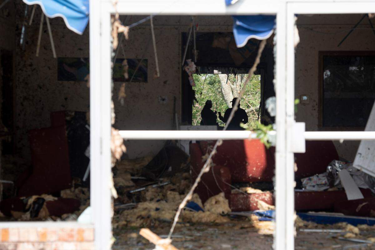 Workers survey a business that sustained damage in Moss Point on Tuesday, June 20, 2023, after a tornado tore through the town on Monday.