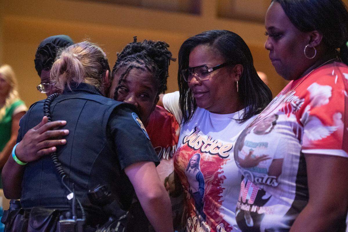 Family members of Anthony Oatis embrace law enforcement officers during a coast-wide candlelight ceremony as a part of National Crime Victims’ Rights Week at First Baptist Church of Gulfport on Tuesday, April 29, 2025. Oatis was killed in June of 2022.