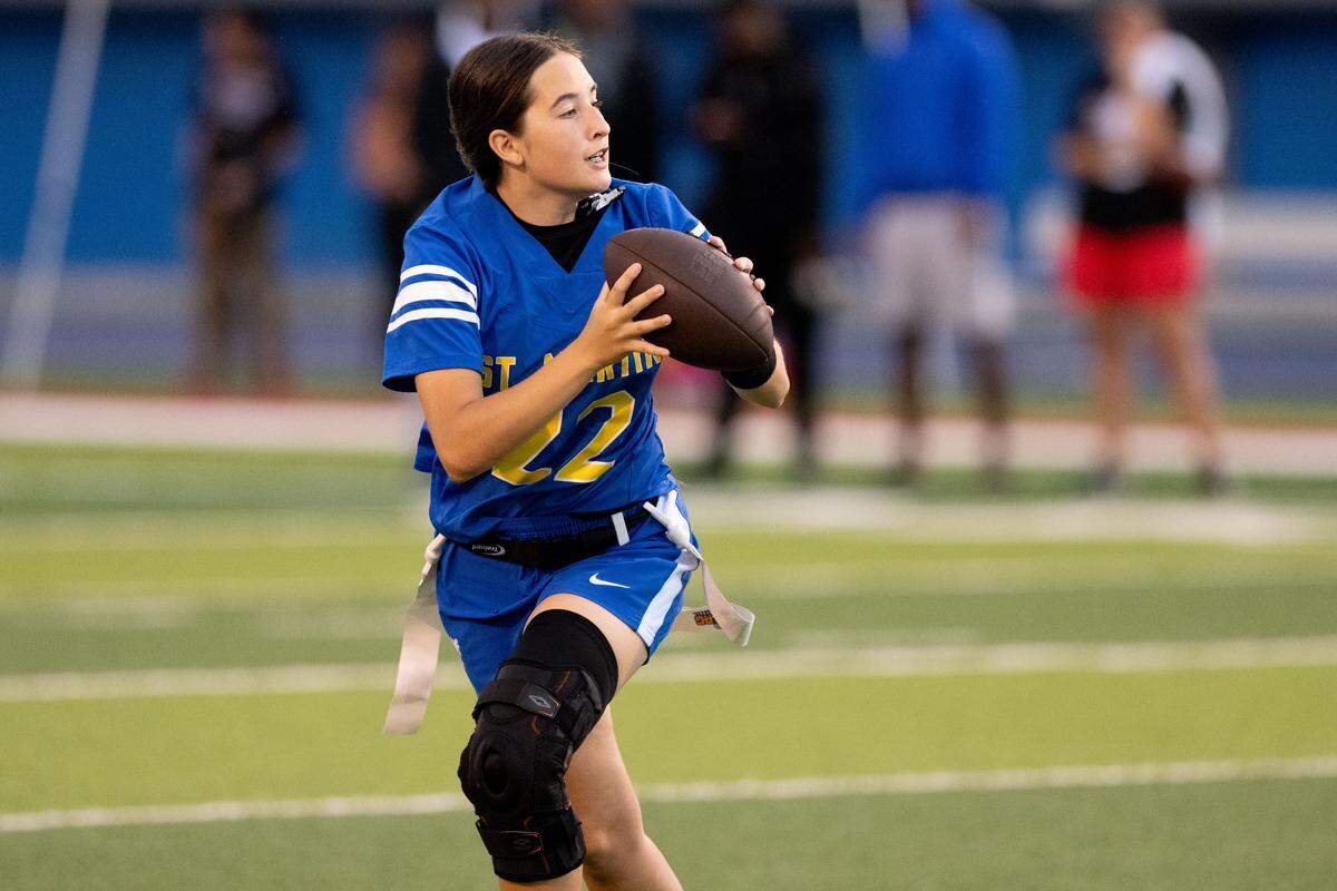 St. Martin’s Emma Chester (22) looks to pass the ball during a flag football playoff game at Pascagoula High School on Thursday, April 30, 2026.