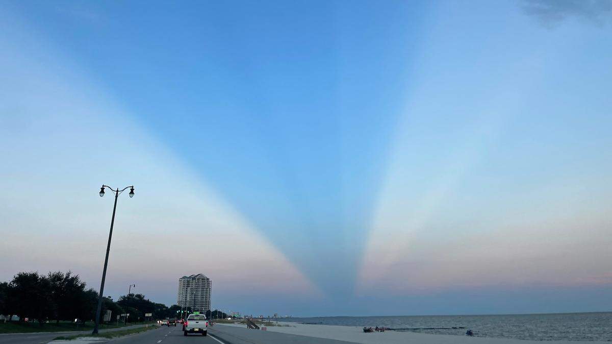 Anticrepuscular rays beamed across the sky on the Biloxi beach on Sunday Sept. 11, 2022.
