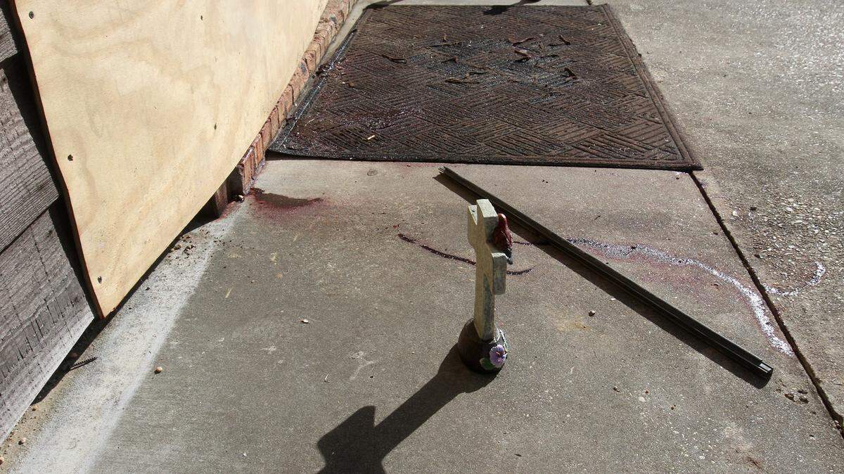 A trio of crosses sit outside the boarded-up front door of McLemore Gun Shop in the Henleyfield community north of Picayune on Sunday Jan. 24, 2016. The owner of the store and his son were shot to death there by another father and son on Saturday Jan. 23, 2106.