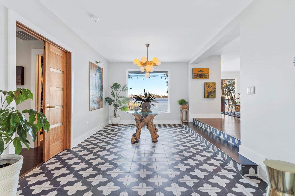 Distinctive tile in the entry and on the fireplaces make a bold statement in this home for sale on the Back Bay in Biloxi.