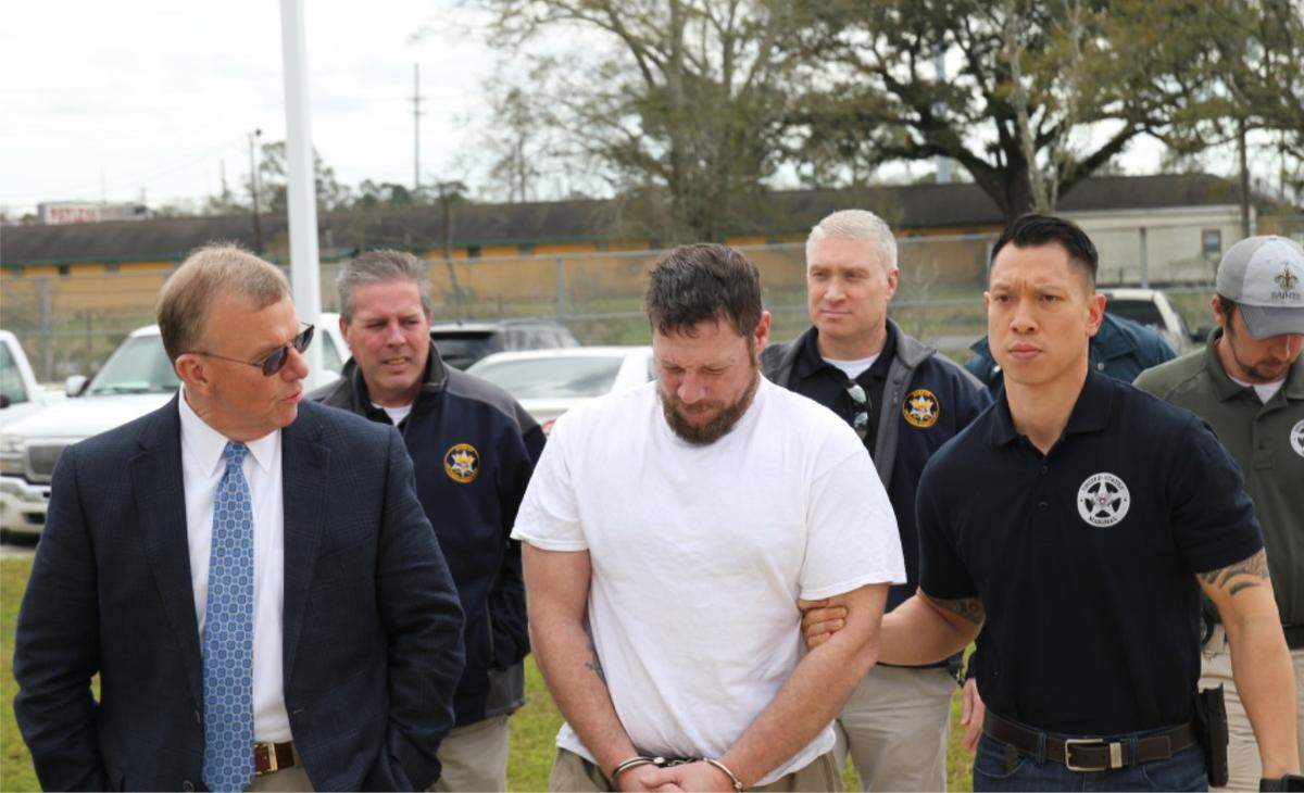 Jacob Blair Scott, center, a most-wanted fugitive who faked his own death to avoid prison for child sex crimes involving a Coast girl, was returned to Jackson County on Wednesday morning, Feb. 26, 2020.