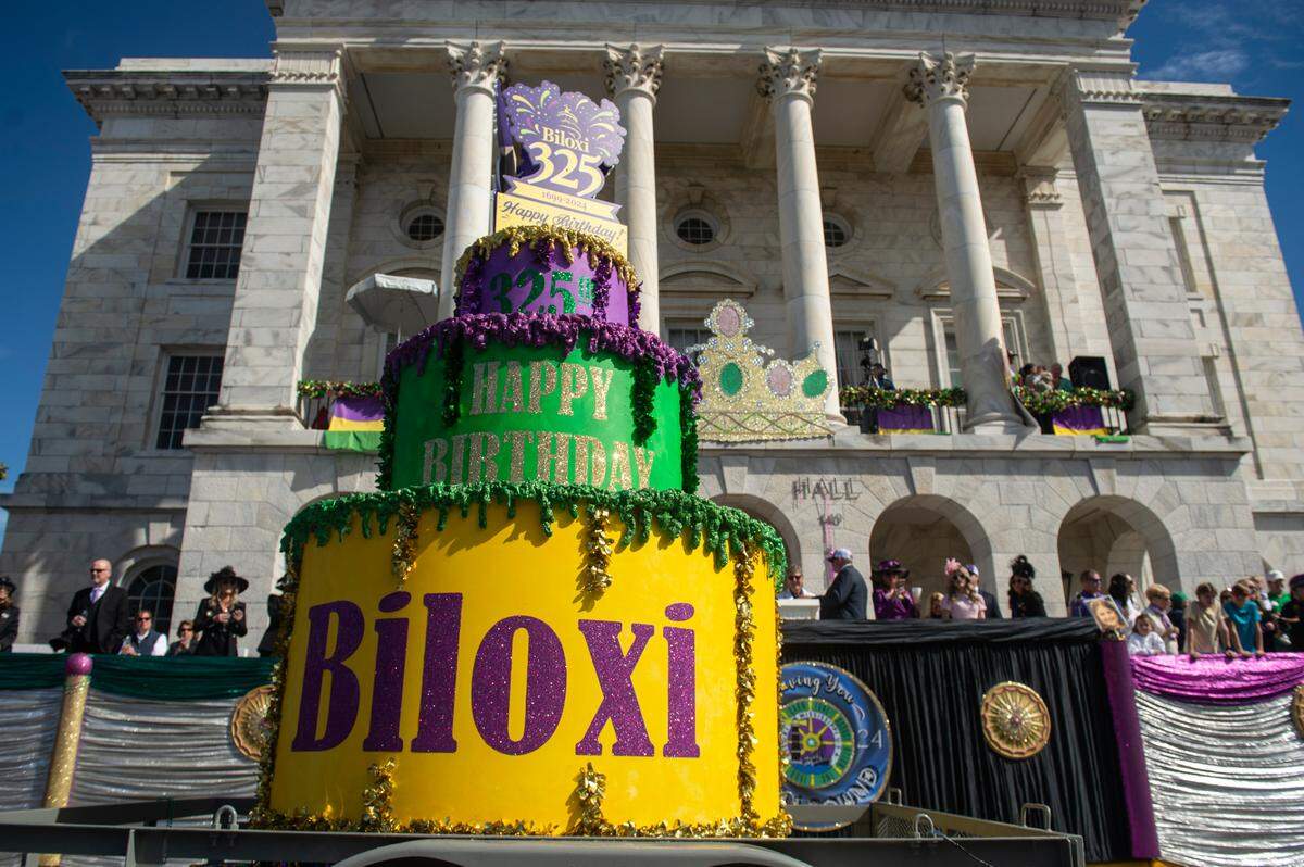 A birthday cake for the city of Biloxi’s 325th birthday passes by city hall during the Gulf Coast Carnival Association’s Mardi Gras parade in Biloxi on Tuesday, Feb. 13, 2024.