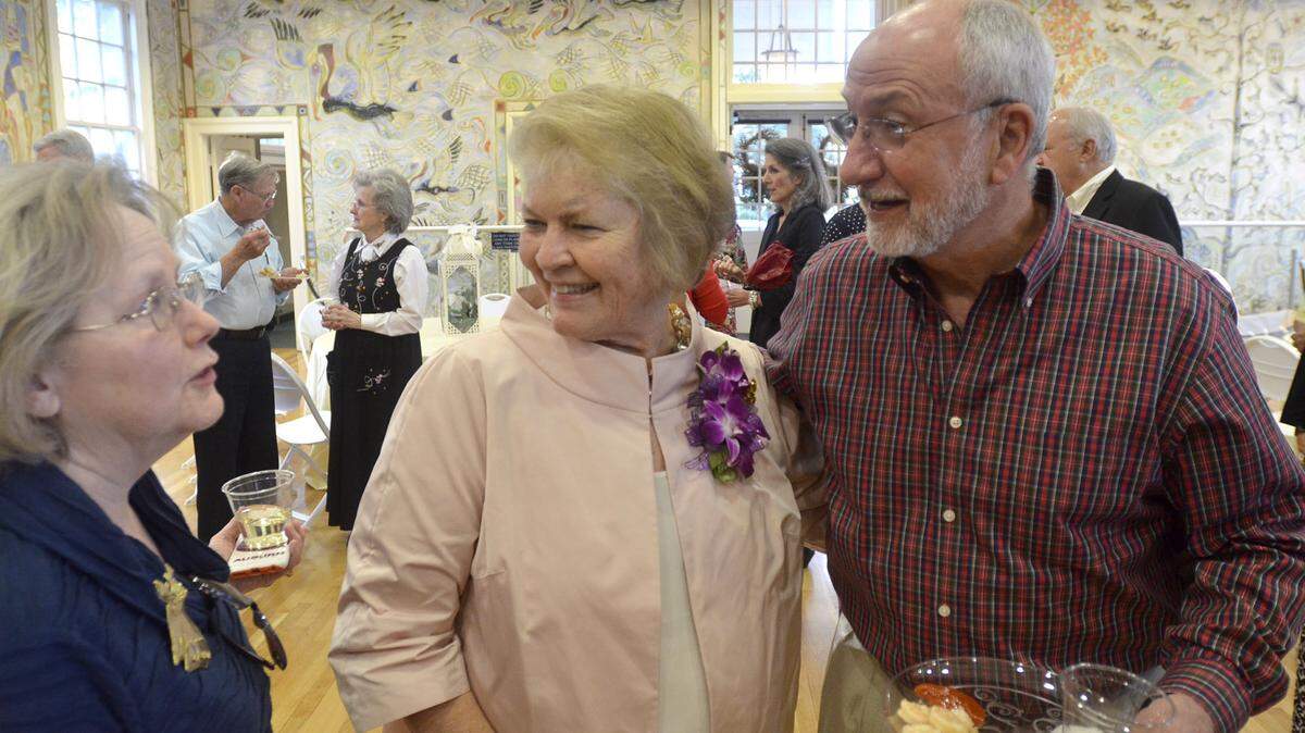 TIM ISBELL/SUN HERALD 
 Margaret Miller, center, receives a hug and congratulations from Judy, left, and Fred Thurman at the Ocean Springs Community Center during Miller's retirement reception, Friday, Dec. 11, 2015.