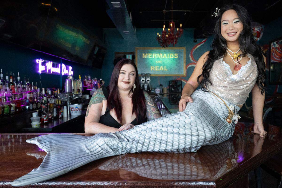 Farabee Rose, left, owner of The Mermaid Dive Bar and Jennifer Quach, right, a bartender, pose for a portrait at the Biloxi bar.