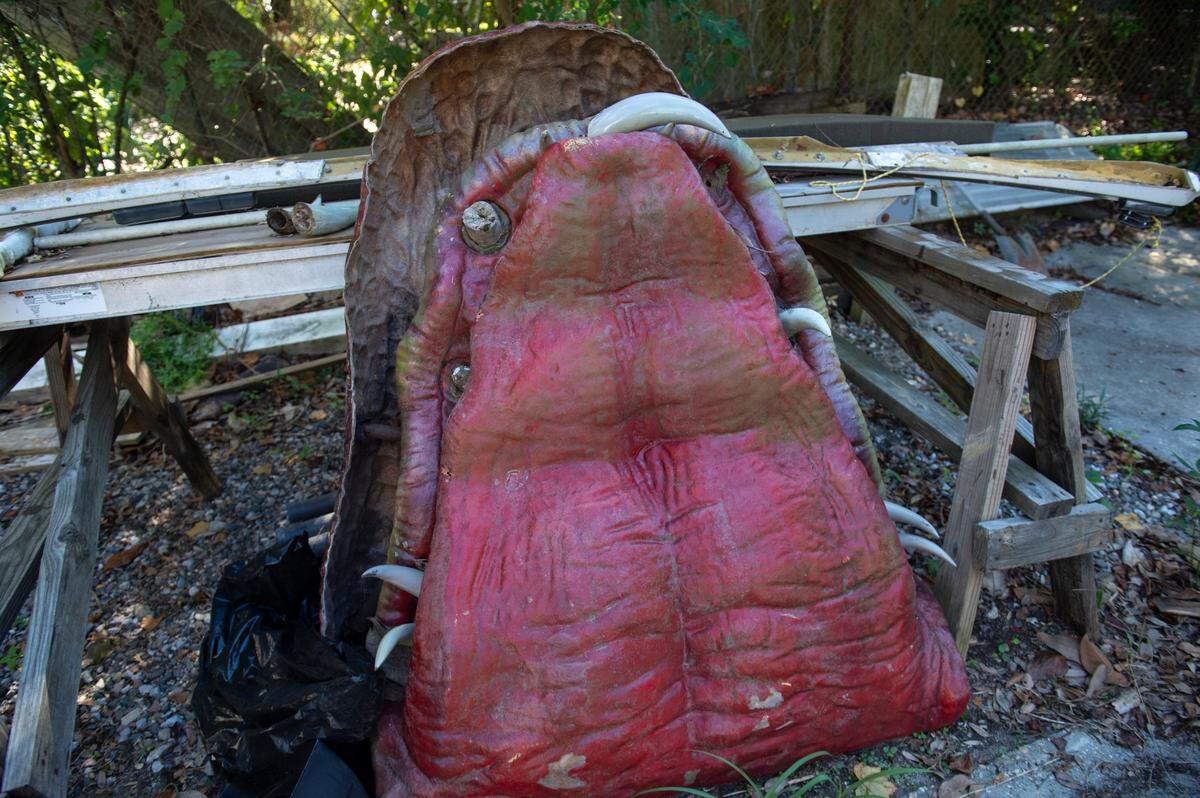 The bottom half of the dragon from the Lady Luck Casino sits in Frank and Marlene Gann’s backyard on Tuesday, Oct. 17, 2023. The dragon, which the Ganns acquired as the casino was closing, has been refitted with different teeth over time.