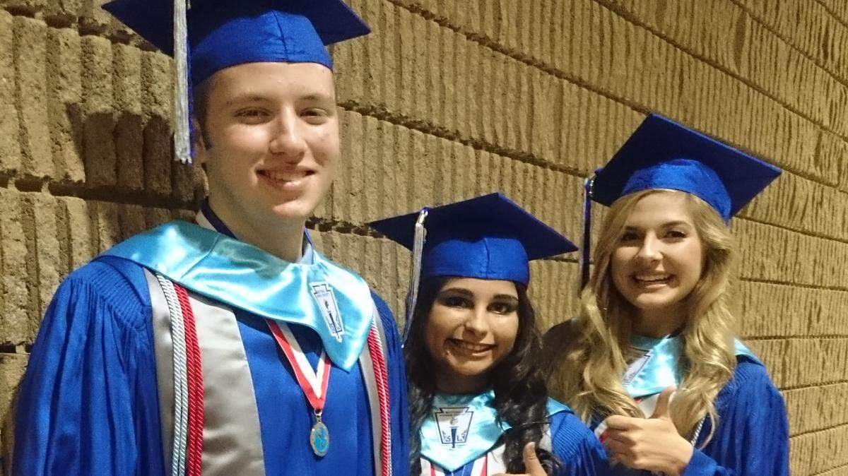 GORDON JACKSON/SPECIAL TO THE SUN HERALD 
 Valedictorian Patrick Cressler, left, salutatorian Sunna Savani and Class Orator Sally Boswell share a thumbs-up moment before Ocean Springs High School's graduation ceremony Thursday, May 26, 2016, at the Coast Coliseum in Biloxi.
