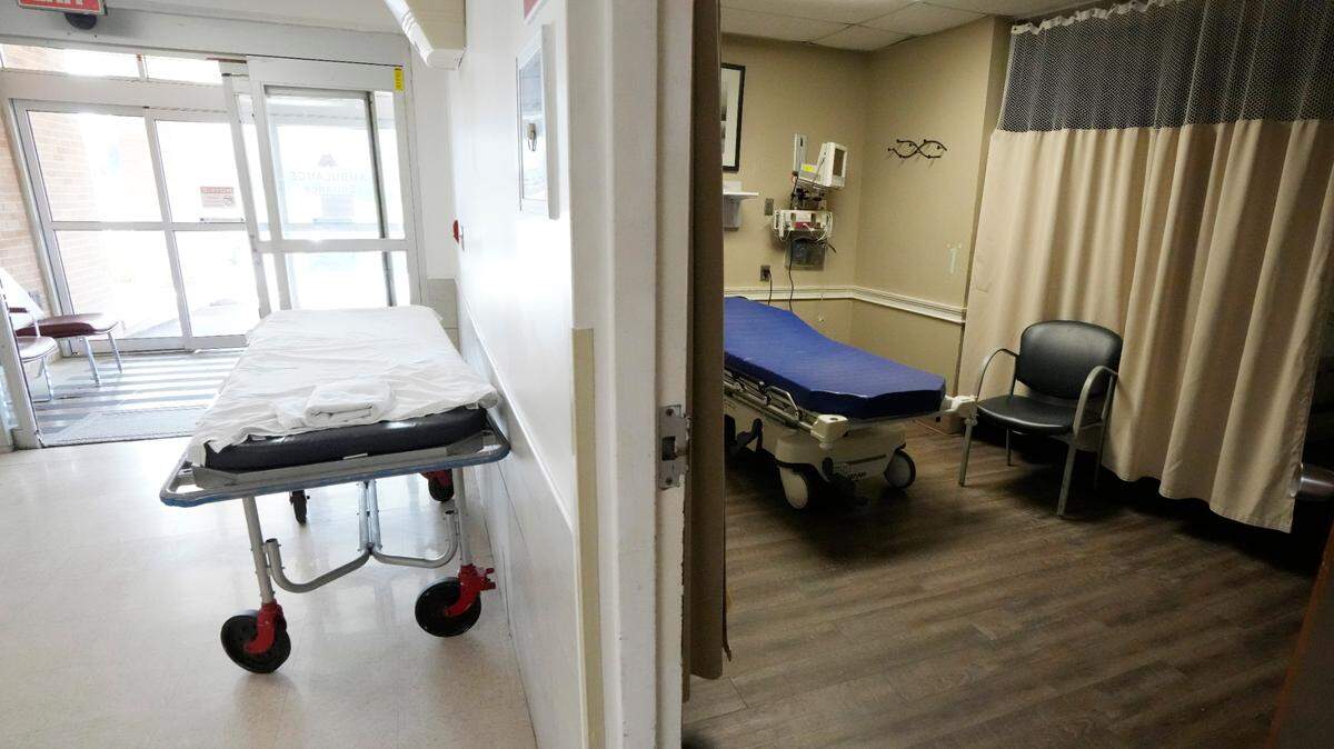 An unused gurney rests in the emergency room hallway outside one of the treatment rooms at the Alliance Healthcare System hospital in Holly Springs earlier this year. Rural emergency hospitals are starting to gain a small foothold in the United States. They provide 24/7 emergency care and receive more than $3 million in federal money a year. But the catch is there are zero inpatient beds at the facilities.